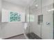 Bathroom featuring a glass-enclosed shower with a window view at 478 Water St, Kissimmee, FL 34747