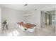 Elegant dining space with a wooden table, white seating, and modern lighting, enhancing the room's appeal at 478 Water St, Kissimmee, FL 34747