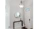 Welcoming entryway featuring a round mirror, modern decor, and ample natural light at 478 Water St, Kissimmee, FL 34747