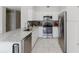Bright kitchen features stainless steel appliances, white cabinets, and marble countertops at 478 Water St, Kissimmee, FL 34747