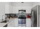 Bright kitchen features stainless steel appliances, granite countertops and modern backsplash at 478 Water St, Kissimmee, FL 34747