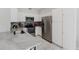 Well-equipped kitchen featuring stainless steel appliances, white cabinets, and luxurious countertops at 478 Water St, Kissimmee, FL 34747