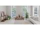 Bright living room featuring large windows, neutral decor, and stylish furnishings at 478 Water St, Kissimmee, FL 34747