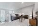 Well-lit living area showcasing a gray sofa, chair, and a minimalist coffee table on light-colored flooring at 478 Water St, Kissimmee, FL 34747