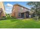 Well-maintained backyard features a screened porch, lush lawn, and inviting outdoor space at 5341 Via Appia Way, Sanford, FL 32771