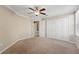Large bedroom featuring carpet flooring, a ceiling fan, a large closet and doorways leading to a bath and hall at 5341 Via Appia Way, Sanford, FL 32771