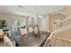 Dining room with modern chandelier and views of the living area at 5341 Via Appia Way, Sanford, FL 32771