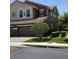 Two-story home featuring a tile roof, a brick-paved driveway, and a two-car garage at 5341 Via Appia Way, Sanford, FL 32771