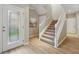 Welcoming foyer with wood flooring, stairs, and a glass-paneled front door at 5341 Via Appia Way, Sanford, FL 32771