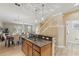 Open kitchen with granite countertops, stainless steel dishwasher, and view of the dining and living room at 5341 Via Appia Way, Sanford, FL 32771