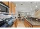 Modern kitchen with stainless steel appliances, granite countertops, and wood cabinets at 5341 Via Appia Way, Sanford, FL 32771