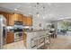 Bright kitchen featuring stainless steel appliances, breakfast bar with pendant lighting, and granite countertops at 5341 Via Appia Way, Sanford, FL 32771