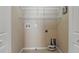 Empty laundry room with white wire shelves, tile floor, and hookups for a washer and dryer at 5341 Via Appia Way, Sanford, FL 32771