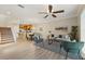 Open-concept living room with dining area, ceiling fan, and stairs leading to the second floor at 5341 Via Appia Way, Sanford, FL 32771