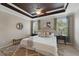 Elegant main bedroom with a decorative ceiling, ambient lighting, and two large windows at 5341 Via Appia Way, Sanford, FL 32771