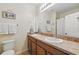 Well-lit bathroom featuring double sinks and a shower, blending functionality with style at 5838 Cypress Hill Rd, Winter Garden, FL 34787