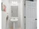 Bathroom featuring a pedestal sink, modern lighting fixtures and neutral wall color at 5838 Cypress Hill Rd, Winter Garden, FL 34787
