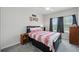 Cozy bedroom with a decorative bed, side tables, and a window letting in natural light at 5838 Cypress Hill Rd, Winter Garden, FL 34787