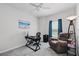 Cozy bedroom features a comfortable recliner, desk area, and carpeted floors at 5838 Cypress Hill Rd, Winter Garden, FL 34787