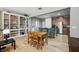 Open dining room and kitchen area with hardwood floors, stylish furniture and built-in shelving at 5838 Cypress Hill Rd, Winter Garden, FL 34787