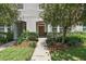 Well-maintained townhouse with landscaped walkway leading to an inviting front door at 5838 Cypress Hill Rd, Winter Garden, FL 34787