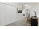 Upstairs hallway featuring multiple closets, neutral carpet, and access to other rooms at 5838 Cypress Hill Rd, Winter Garden, FL 34787