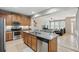 Open kitchen featuring a stainless steel dishwasher, and a view of the living room at 5838 Cypress Hill Rd, Winter Garden, FL 34787