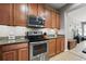 Kitchen featuring granite countertops, wood cabinets and stainless steel appliances at 5838 Cypress Hill Rd, Winter Garden, FL 34787