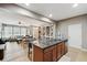 Kitchen island with a sink and breakfast bar seating with a view of the living room at 5838 Cypress Hill Rd, Winter Garden, FL 34787