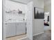 Laundry room featuring a washer and dryer next to a wire rack shelf, offering convenience at 5838 Cypress Hill Rd, Winter Garden, FL 34787
