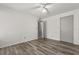 Spacious bedroom with wood-look floors, a ceiling fan, and closet at 6178 Westgate Dr # 101, Orlando, FL 32835