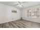 A bright bedroom with new floors, a ceiling fan, and windows providing natural light at 6178 Westgate Dr # 101, Orlando, FL 32835