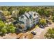 An aerial view of a well-maintained condominium complex surrounded by lush greenery and ample parking at 6178 Westgate Dr # 101, Orlando, FL 32835