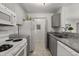 A functional kitchen with grey cabinets, granite countertops, and modern appliances at 6178 Westgate Dr # 101, Orlando, FL 32835