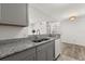 Updated kitchen features gray cabinets, granite countertops, and stainless steel appliances at 6178 Westgate Dr # 101, Orlando, FL 32835