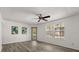 An inviting living room with new floors, neutral walls, a ceiling fan, and an exterior glass door at 6178 Westgate Dr # 101, Orlando, FL 32835