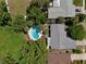 Overhead shot showcases a home with a kidney-shaped pool offering a private backyard oasis surrounded by trees at 623 Green Meadow Ave, Maitland, FL 32751