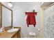 Bathroom features a vanity with a mirror, decorative shelf, toilet and shower behind a curtain at 623 Green Meadow Ave, Maitland, FL 32751