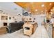 Open-concept kitchen features stainless steel appliances, tile floors, wood ceilings and a hanging pot rack at 623 Green Meadow Ave, Maitland, FL 32751