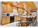 Well-equipped kitchen featuring wooden cabinets, countertop space, and a breakfast bar with seating for casual dining at 623 Green Meadow Ave, Maitland, FL 32751
