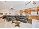 Large living room with wood ceilings, tile flooring, and a large sectional sofa adjacent to the kitchen at 623 Green Meadow Ave, Maitland, FL 32751