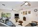 Comfortable living room features tile floors, ceiling fans, and a sliding glass door to the outside patio at 623 Green Meadow Ave, Maitland, FL 32751