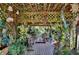 Cozy outdoor pergola filled with lush plants and decorative accents creating a tranquil retreat at 623 Green Meadow Ave, Maitland, FL 32751