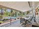 Screened patio dining area with seating and lovely views of the pool and backyard oasis at 623 Green Meadow Ave, Maitland, FL 32751