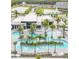 Aerial view of a resort-style pool area with a lazy river, multiple pools, and palm tree landscaping at 6301 Sand Skipper Rd, Orlando, FL 32821