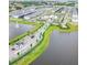 Aerial view of a Primary-planned community featuring multiple lakes, a community center, and rows of modern homes at 6301 Sand Skipper Rd, Orlando, FL 32821