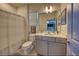 Bright bathroom featuring a gray vanity with a white countertop and shower with decorative curtain at 6301 Sand Skipper Rd, Orlando, FL 32821