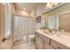 This bathroom features neutral tile, bright lighting, plus modern fixtures, and a window for natural light at 6301 Sand Skipper Rd, Orlando, FL 32821
