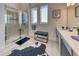 Bright bathroom featuring a glass-enclosed shower, double windows, vanity, and a stylish cowhide rug at 6301 Sand Skipper Rd, Orlando, FL 32821