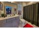 Modern bathroom featuring gray vanity with white countertops and Spiderman themed art at 6301 Sand Skipper Rd, Orlando, FL 32821